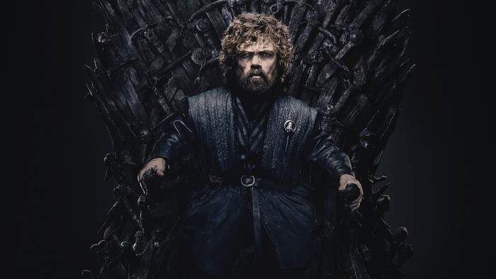 Tyrion Lannister from Game of Thrones sitting on the Iron Throne