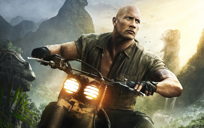 Dwayne Johnson riding a motorcycle in a jungle
