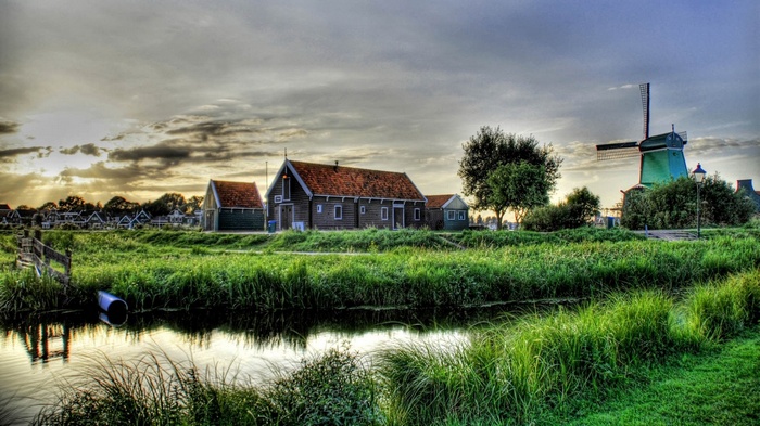 Dutch village with windmill and canal