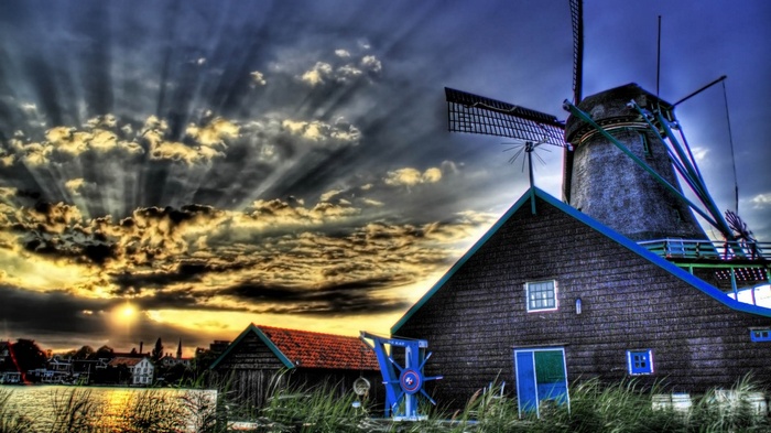 Windmill and dramatic sunset over a canal