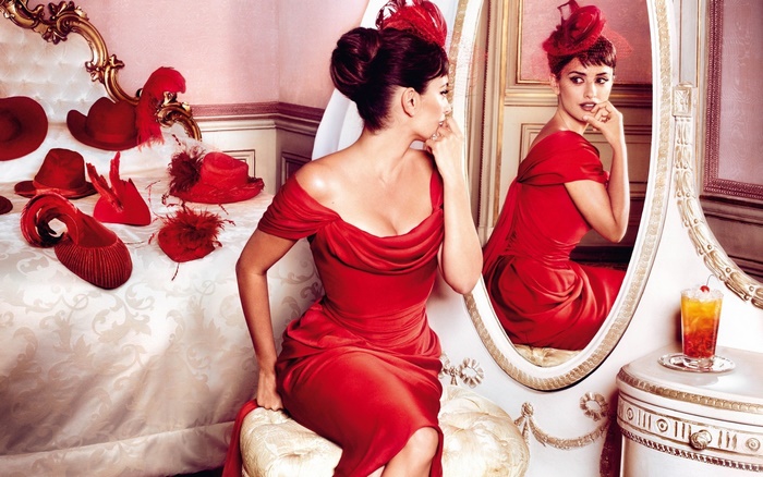 Penélope Cruz in a red dress with hats