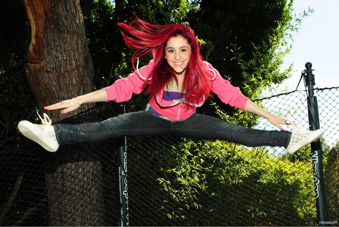 Ariana Grande jumping in a split