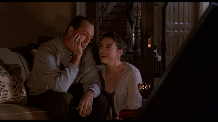 Bruce Willis and woman sitting on couch