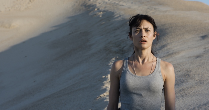 Olga Kurylenko in a desert landscape
