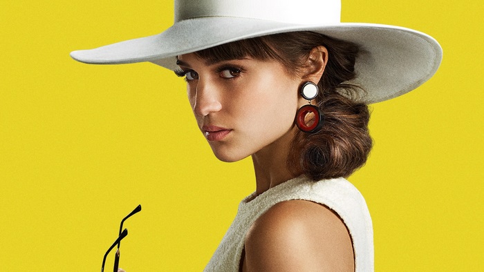 Alicia Vikander wearing a white hat and earrings