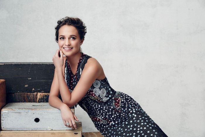 Alicia Vikander posing on wooden crates