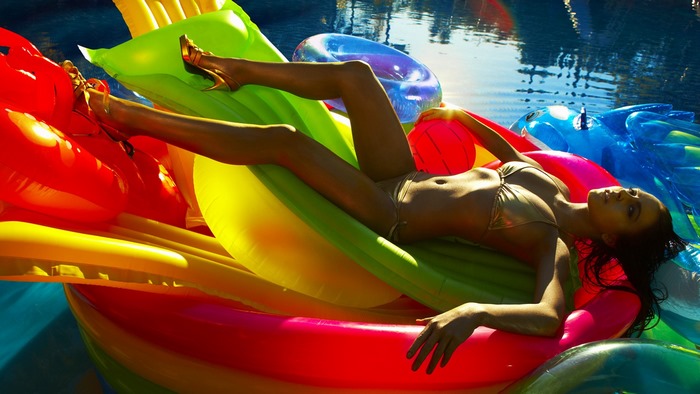 Lindsay Lohan on inflatable rafts in a pool