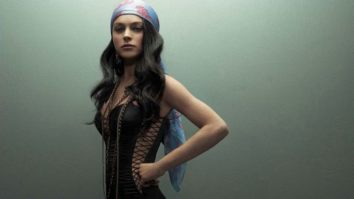 Lindsay Lohan in a black corset and headscarf