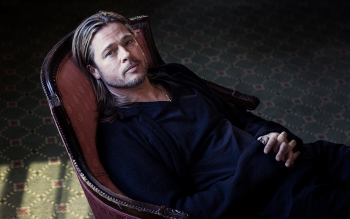 Brad Pitt sitting in a chair