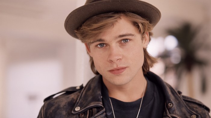 Brad Pitt wearing a hat and leather jacket