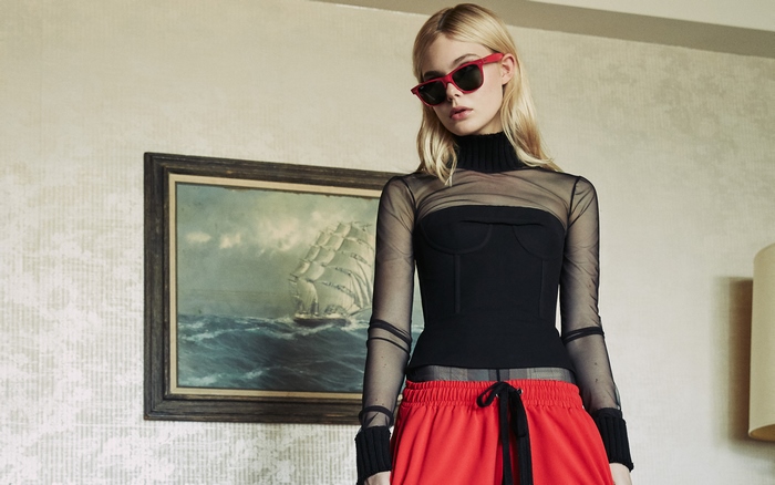 Elle Fanning in red sunglasses and black top