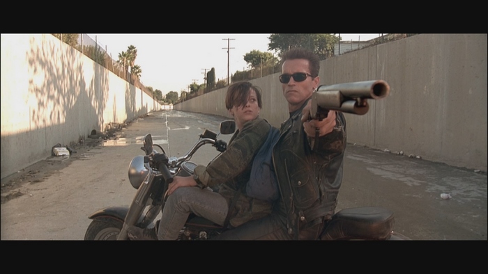 Arnold Schwarzenegger and Linda Hamilton on a motorcycle