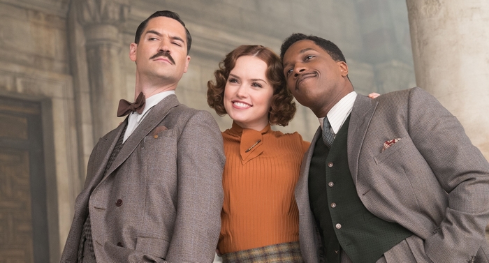 Daisy Ridley and two men in suits