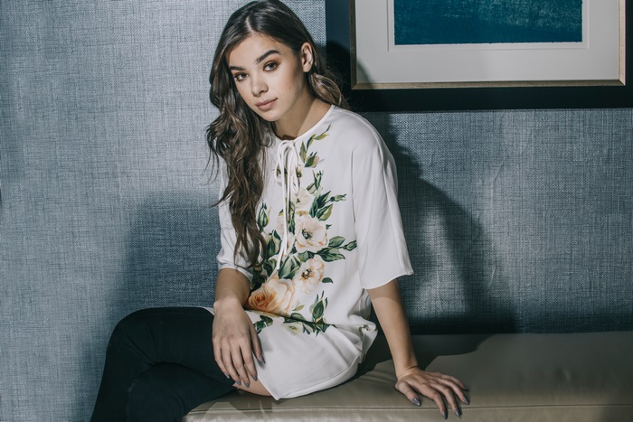 Hailee Steinfeld Sitting on Bench in Floral Top