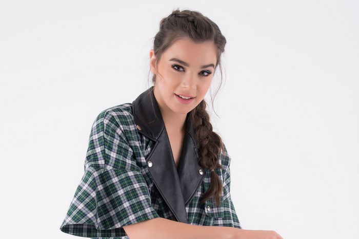 Smiling Hailee Steinfeld in Plaid Jacket with Leather Collar