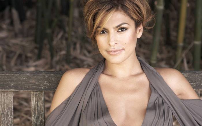 Eva Mendes sitting on a bench