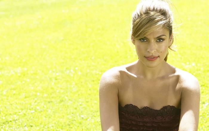 Eva Mendes in a strapless dress on a grassy field