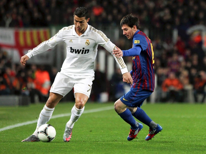 Cristiano Ronaldo and Lionel Messi playing soccer