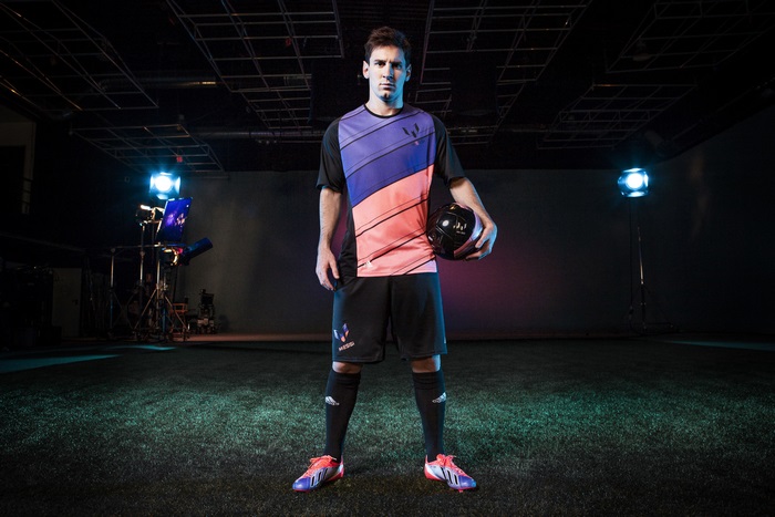 Lionel Messi holding a soccer ball
