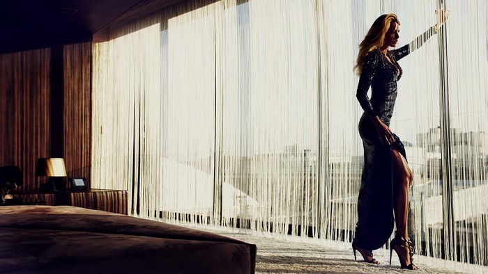 Blake Lively in a long dress by the window