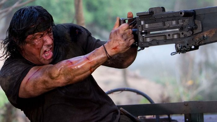 Sylvester Stallone firing a machine gun