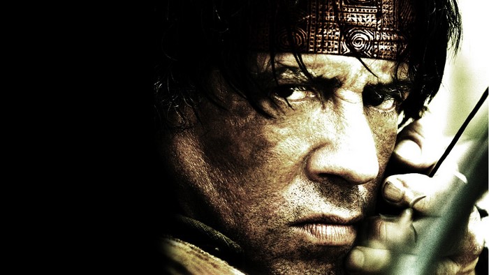 Sylvester Stallone as Rambo with a bow