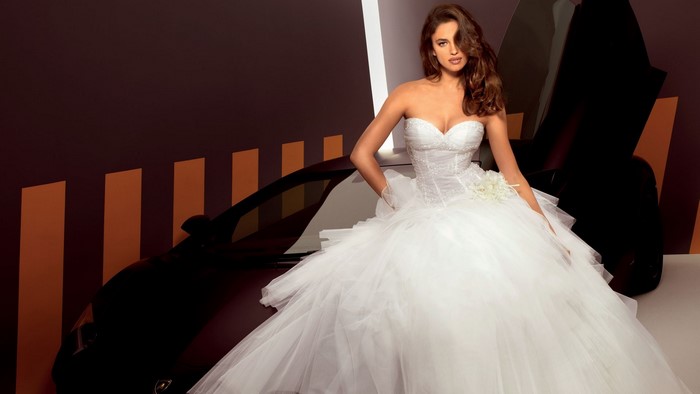 Irina Shayk in a wedding dress with a car