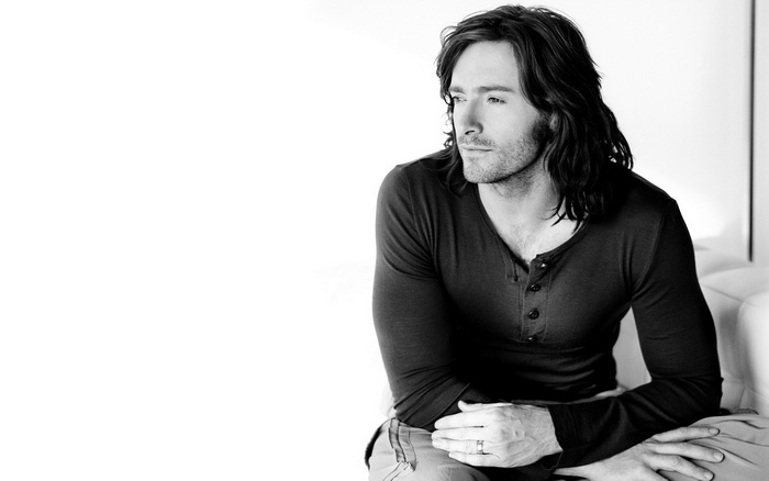 Man with long hair sitting