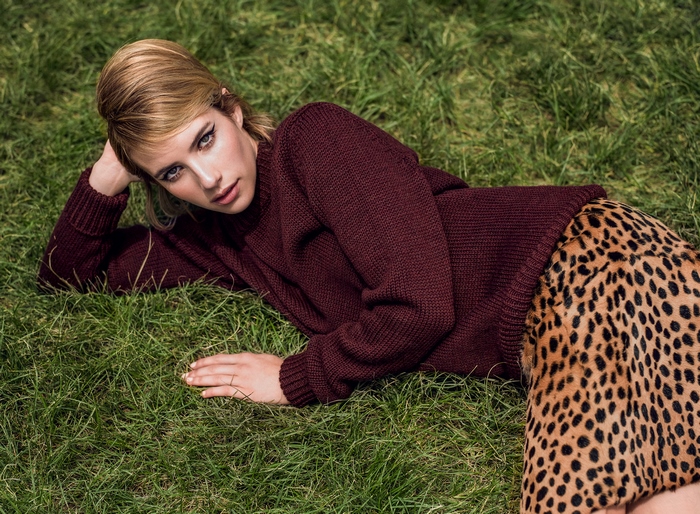 Emma Roberts lying on grass in cozy fall outfit