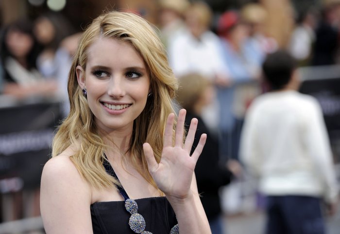 Emma Roberts waving at an event