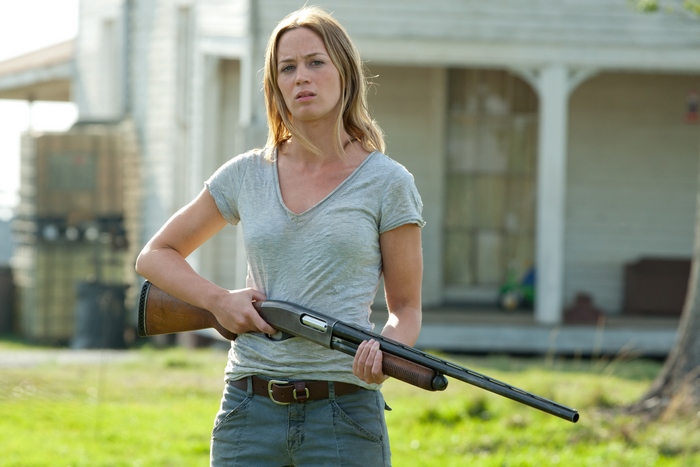Emily Blunt holding a shotgun