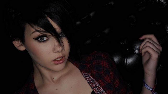 Woman with dark hair and plaid shirt