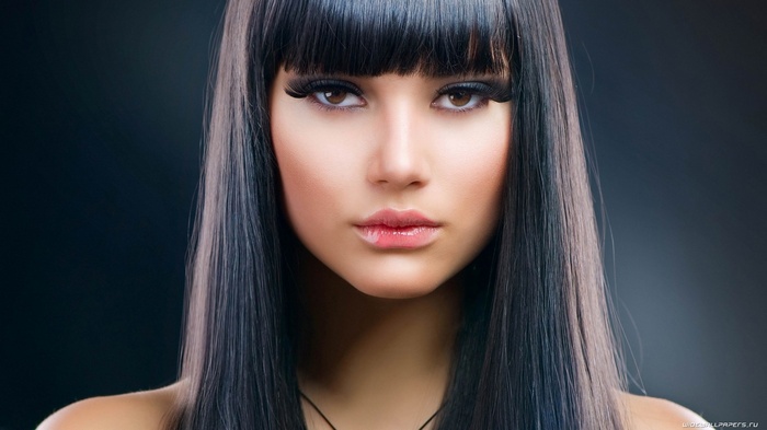 Woman with long black hair and bangs