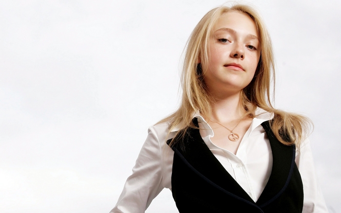 Dakota Fanning in a white shirt and vest