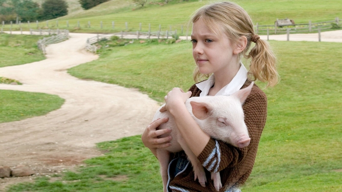 Dakota Fanning holding a piglet