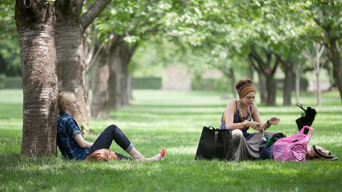 Dakota Fanning and companion in a park