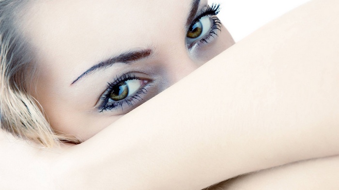 Close-up of a woman's eyes and arm
