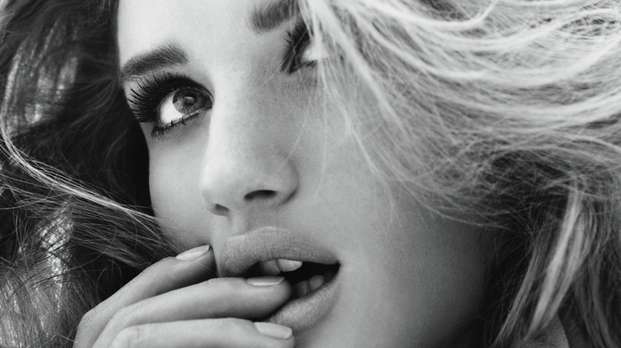 Close-up of a woman biting her finger