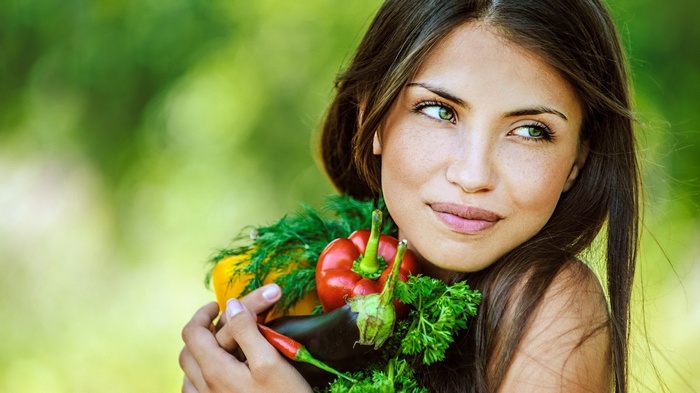 Woman holding fresh vegetables outdoors