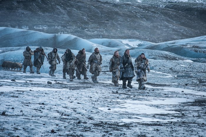 Group of men walking across a frozen landscape