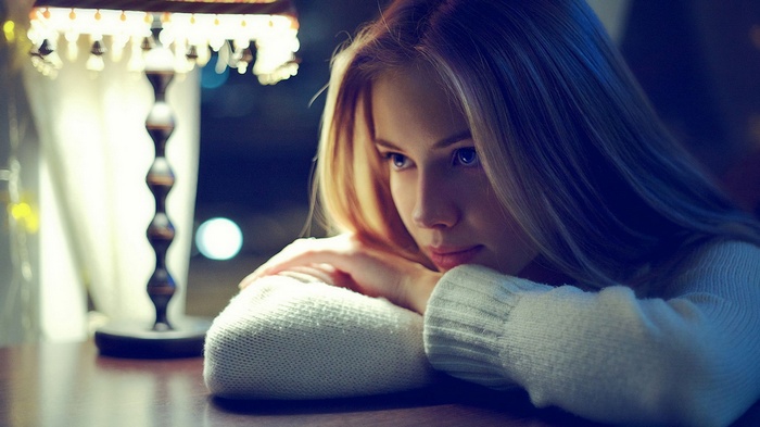 Young woman resting her head on her arms