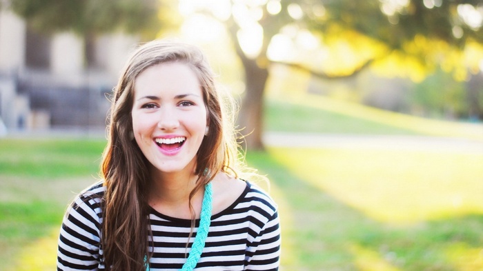 Young woman laughing outdoors