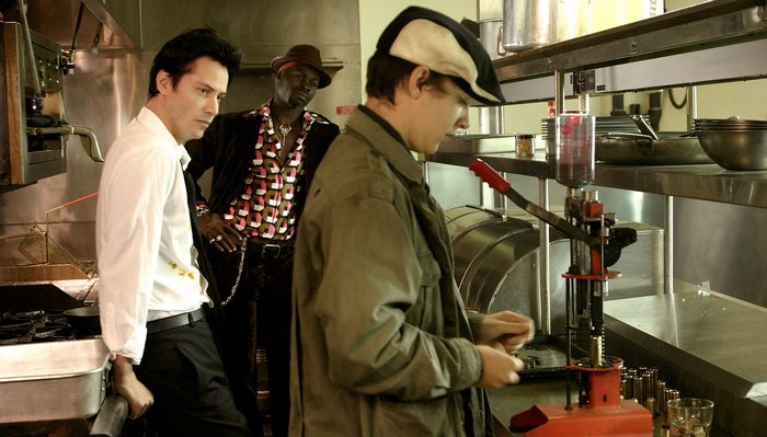 Keanu Reeves and two men in a kitchen