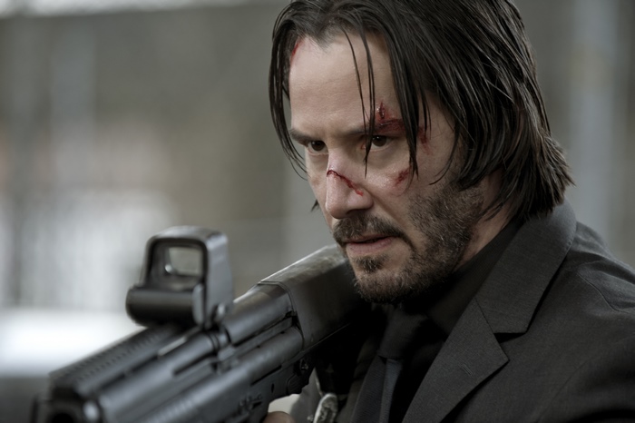 Keanu Reeves holding a rifle