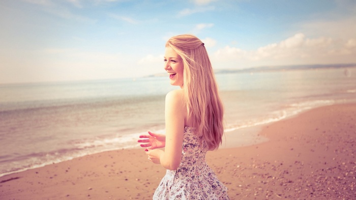 Woman in a floral dress on a beach