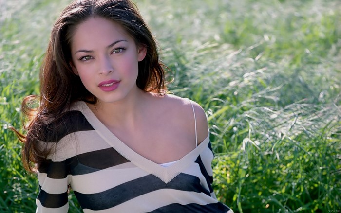 Kristin Kreuk in a striped top outdoors