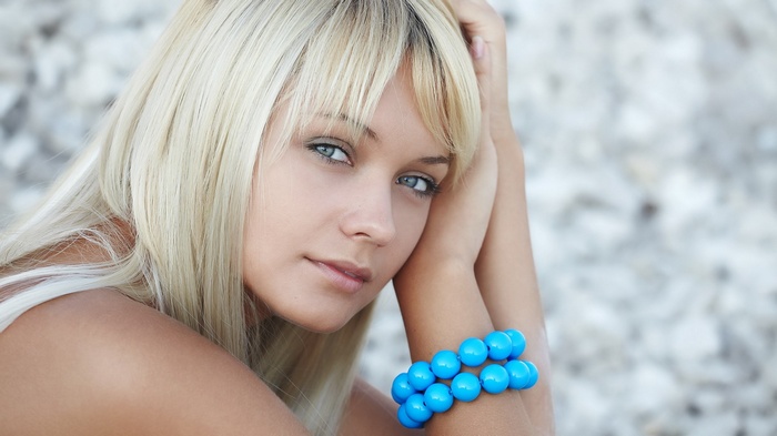 Young woman with blonde hair and blue bracelet