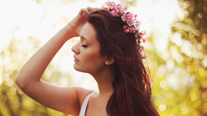Woman with flower crown in sunlight