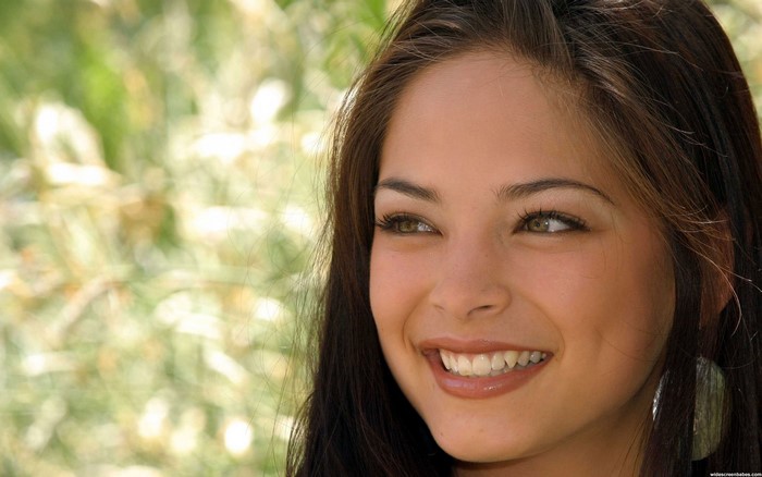 Kristin Kreuk smiling outdoors