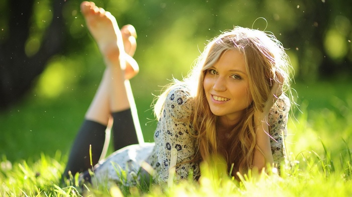 Young woman lying in grass